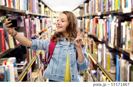teenage student girl taking selfie by smartphone teenage student girl taking selfie by smartphone 55571867
