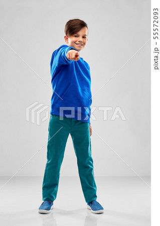 smiling boy in blue hoodier pointing finger smiling boy in blue hoodier pointing finger 55572093
