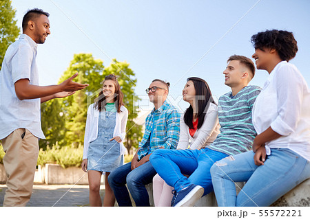 happy international friends talking in city 55572221