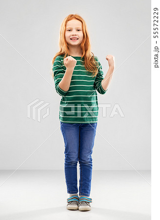 smiling red haired girl celebrating success 55572229