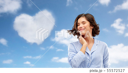 happy young woman in pajama over sky background happy young woman in pajama over sky background 55572527