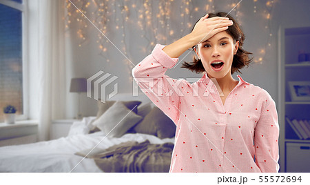 confused young woman in pajama over night bedroom confused young woman in pajama over night bedroom 55572694