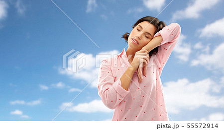 sleepy woman in pajama napping over sky 55572914