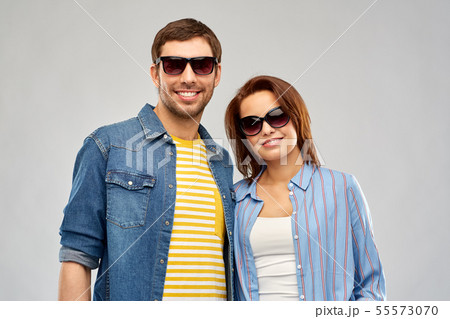 happy couple in sunglasses over grey background happy couple in sunglasses over grey background 55573070