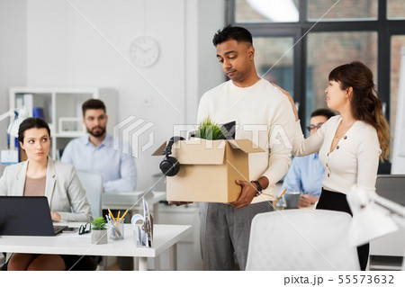 colleague seeing off sad fired male office worker 55573632