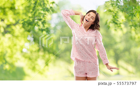happy young woman in pajama stretching happy young woman in pajama stretching 55573797