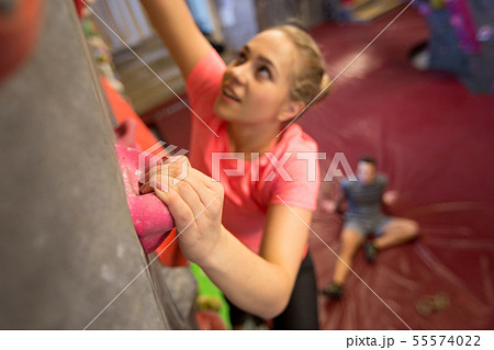 young woman exercising at indoor climbing gym 55574022