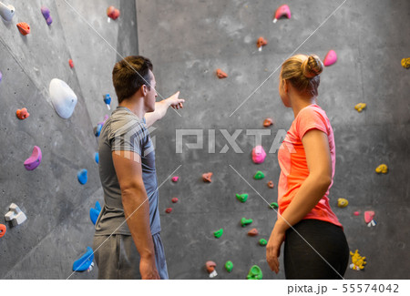 man and woman exercising at indoor climbing gym 55574042