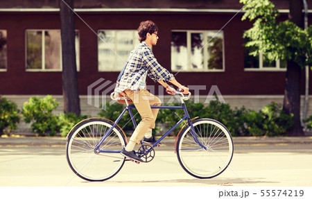 young hipster man with bag riding fixed gear bike young hipster man with bag riding fixed gear bike 55574219