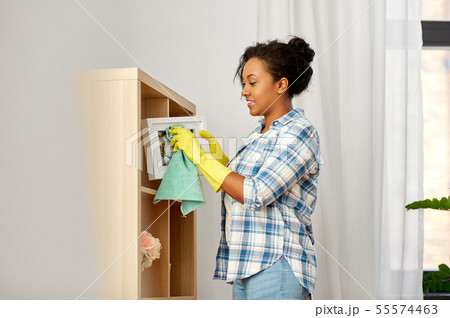 happy woman with cloth dusting at home happy woman with cloth dusting at home 55574463