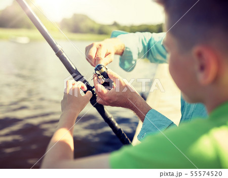 boy and grandfather with fishing rod on river 55574520