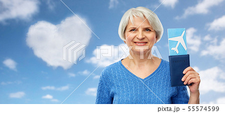 senior woman with passport and airplane ticket senior woman with passport and airplane ticket 55574599