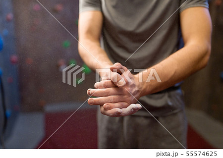male climber drying hands at indoor climbing gym male climber drying hands at indoor climbing gym 55574625