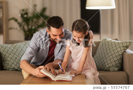 father and daughter doing homework together 55574707