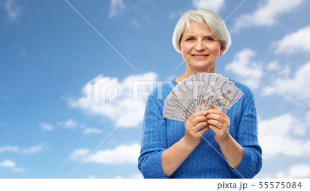 senior woman with hundred dollar money banknotes 55575084