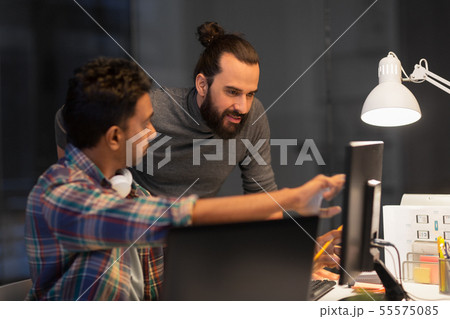 creative team with computer working late at office creative team with computer working late at office 55575085