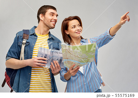 happy couple of tourists with city guide and map 55575169
