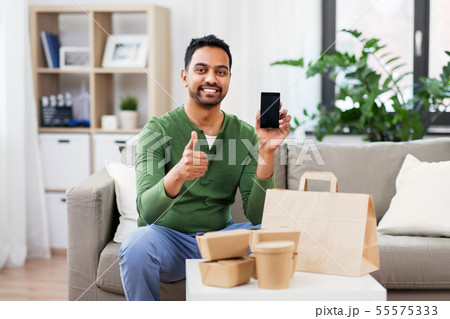 indian man using smartphone for food delivery indian man using smartphone for food delivery 55575333