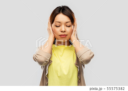 asian woman closing ears by hands 55575382