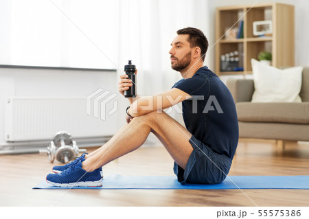 man drinking water during training at home man drinking water during training at home 55575386