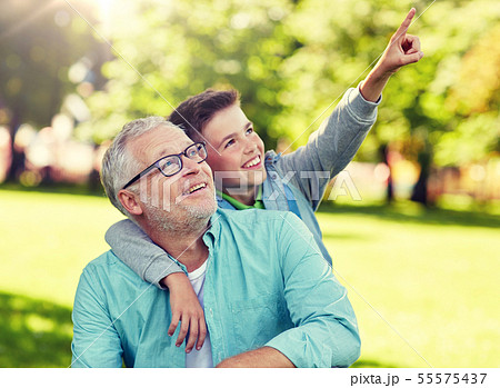 grandfather and boy pointing finger at summer park grandfather and boy pointing finger at summer park 55575437
