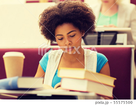 student girl with books and coffee on lecture 55575500