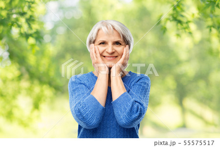 portrait of smiling senior woman in blue sweater 55575517