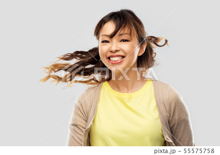 happy asian woman with waving hair 55575758