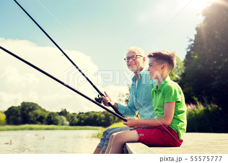 grandfather and grandson fishing on river berth grandfather and grandson fishing on river berth 55575777