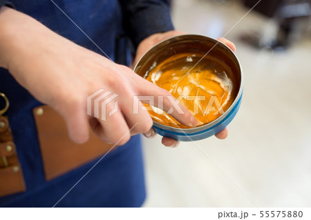 hairstylist's hands with hair styling wax hairstylist's hands with hair styling wax 55575880