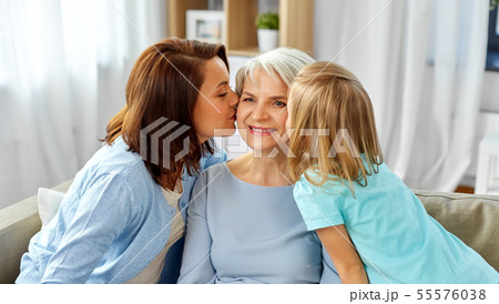 mother and daughter kissing happy grandmother mother and daughter kissing happy grandmother 55576038