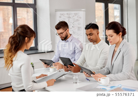 team of recruiters with tablet pc at job interview team of recruiters with tablet pc at job interview 55576371