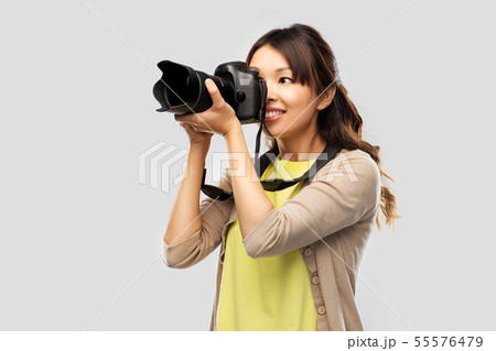 asian female photographer with digital camera 55576479