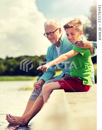 grandfather and grandson sitting on river berth grandfather and grandson sitting on river berth 55576491