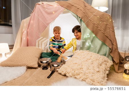 boys with pots playing music in kids tent at home boys with pots playing music in kids tent at home 55576651