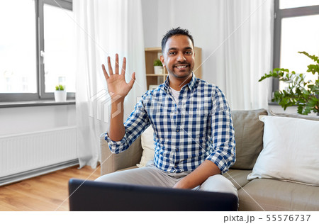 indian male blogger waving hand at home indian male blogger waving hand at home 55576737