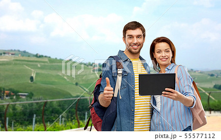 happy couple of tourists with tablet computer happy couple of tourists with tablet computer 55577112