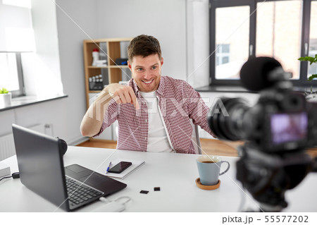 male blogger with camera videoblogging at home male blogger with camera videoblogging at home 55577202