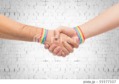 hands with gay pride wristbands make handshake hands with gay pride wristbands make handshake 55577337