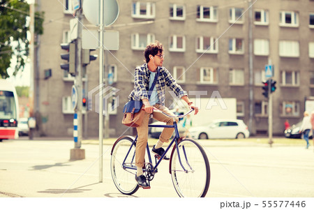 young hipster man with bag riding fixed gear bike 55577446