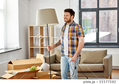 happy man with floor lamp moving to new home happy man with floor lamp moving to new home 55577592