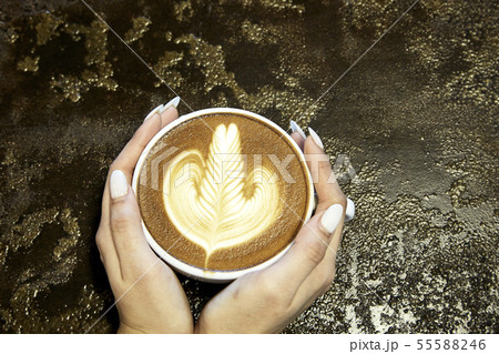 Close-Up Of Woman Holding Coffee 55588246