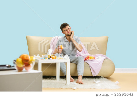 Young man suffering from allergy to citrus fruits Young man suffering from allergy to citrus fruits 55591042