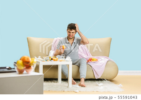 Young man suffering from allergy to citrus fruits 55591043