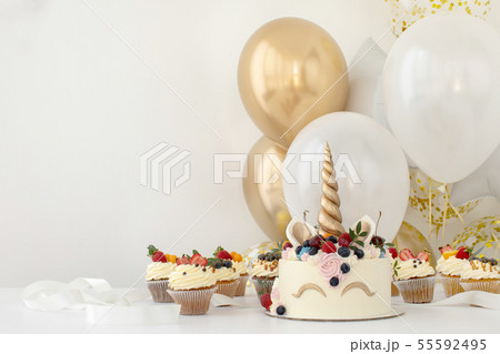 Close up of little girl's birthday party table with unicorn cake Close up of little girl's birthday party table with unicorn cake 55592495