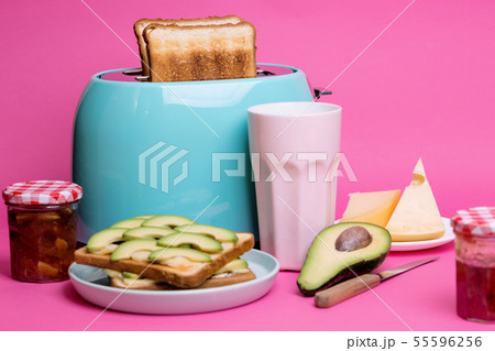 cyan color toaster on a pink background 55596256