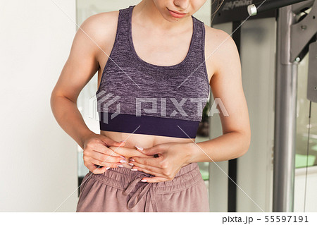 Unhappy young sporty girl. Skin fold test Unhappy young sporty girl. Skin fold test 55597191