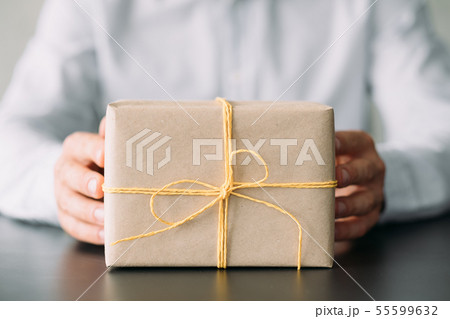 corporate birthday party beige paper gift box hands corporate birthday party beige paper gift box hands 55599632