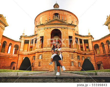 happy family in italy mother and daughter at the San Luca sanctuary church of Bologna in Emilia happy family in italy mother and daughter at the San Luca sanctuary church of Bologna in Emilia 55599843