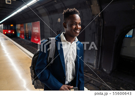 African American businessman wearing blue suit and backpack 55600643